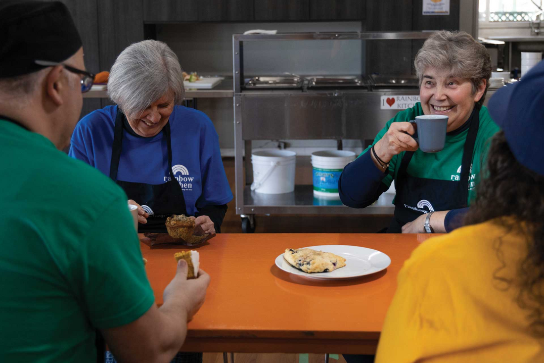 A group of Rainbow Kitchen volunteers at a table.