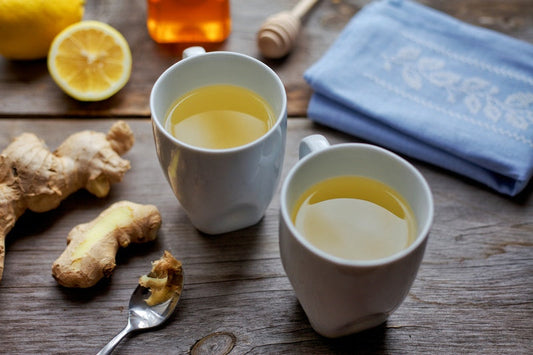 Two mugs of lemon, honey, ginger tea. 